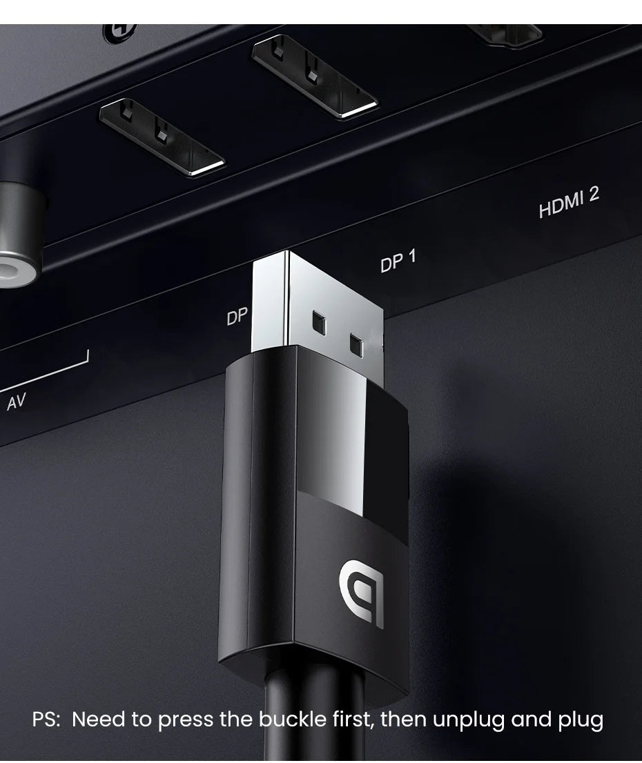 Close-up of a black and silver USB-C cable connector plugged into a dark display panel with HDMI and DP ports visible.