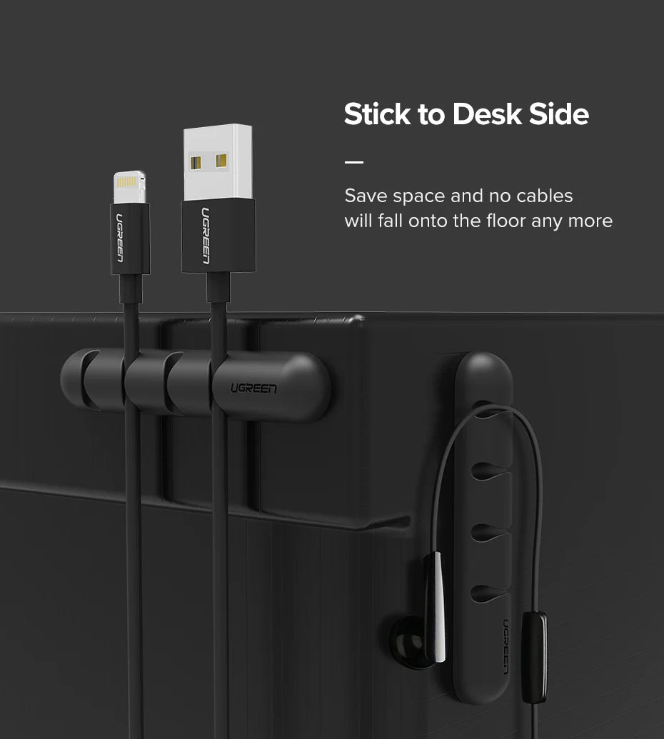 Ugreen cable management system with USB cable and earbuds on a black surface.