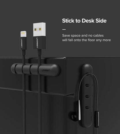 Ugreen cable management system with USB cable and earbuds on a black surface.