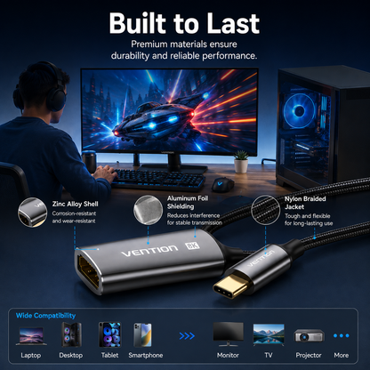 Vention HDMI 2.1x2 adapter shown in a dark studio-style setup with a person seated at a computer in the background, plus callout details about zinc alloy shell, aluminum foil shielding, and nylon braided jacket.