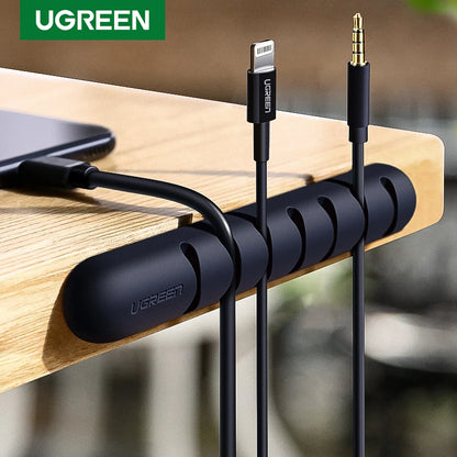UGREEN cable organizer with cables on a wooden surface