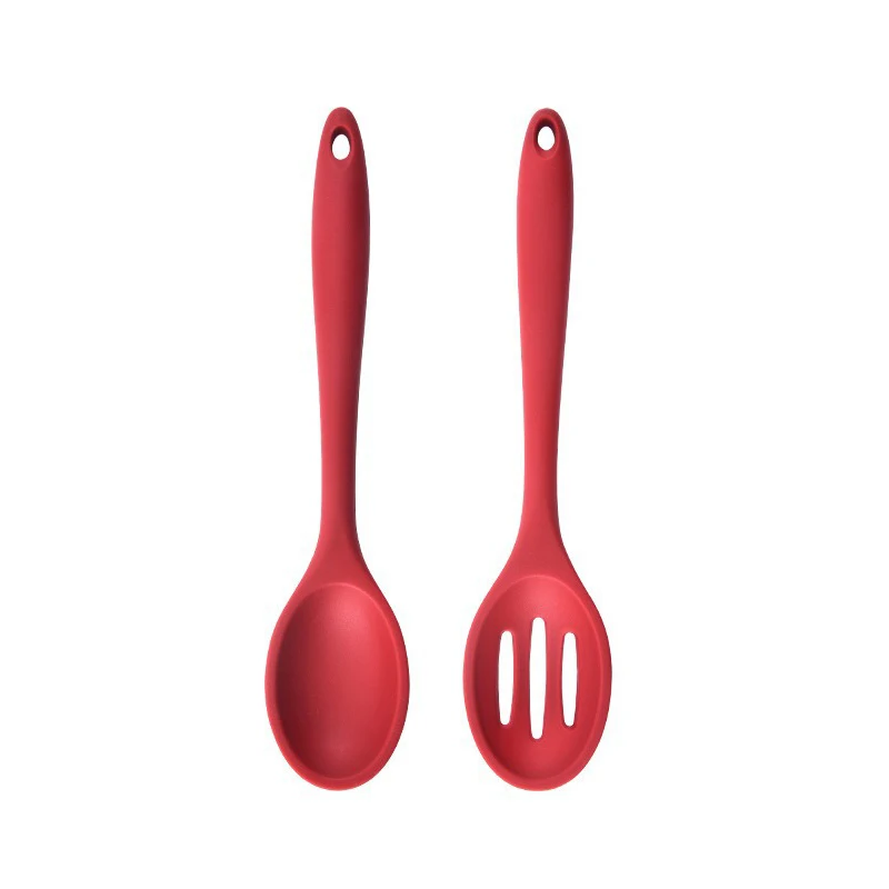 Two red silicone utensils on a white background