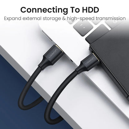 USB cable connecting to an external hard drive with text on a blurred background