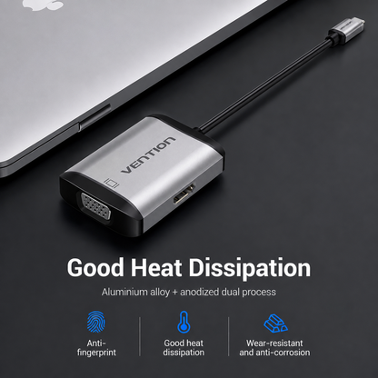 A Vention USB-C to HDMI adapter with a brushed silver aluminum body and black accents, shown plugged into a laptop on a dark surface. The image includes marketing text highlighting its heat dissipation and features like anti-fingerprint coating.