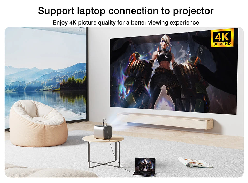 A projector connected to a large wall-mounted screen in a modern living room, projecting a 4K image. A laptop sits on a small table nearby, and the scene includes a beanbag chair, a window view of a lake and mountains, and promotional text at the top about supporting laptop connection to projector.