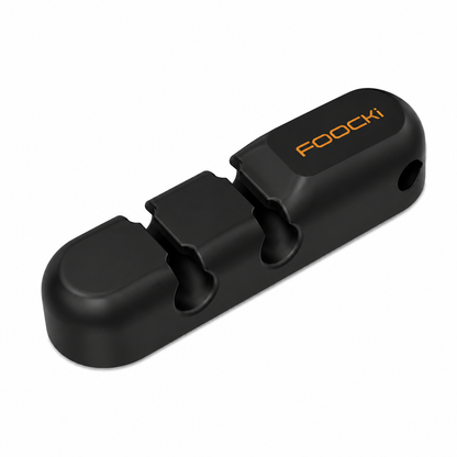 A black FOOCKi automatic knife sharpener with a matte finish and orange brand lettering, shown on a clean white background.