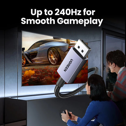 A silver and black USB gaming adapter labeled 'VOGUEEN' is shown floating in front of a TV screen with a racing car image, with two people seated in a dimly lit room holding game controllers. Large text at the top reads 'Up to 240Hz for Smooth Gameplay'.