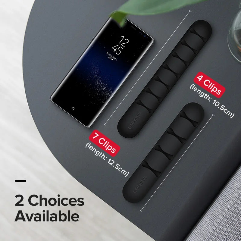 Black clips with measurements and smartphone displaying a smoking icon on a gray surface.