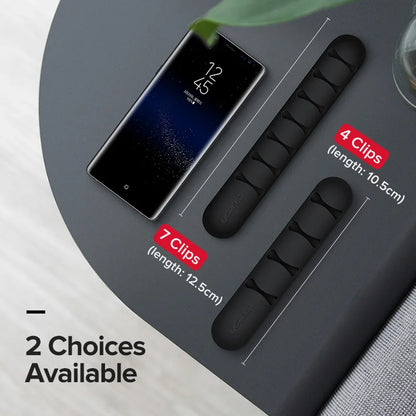 Black clips with measurements and smartphone displaying a smoking icon on a gray surface.
