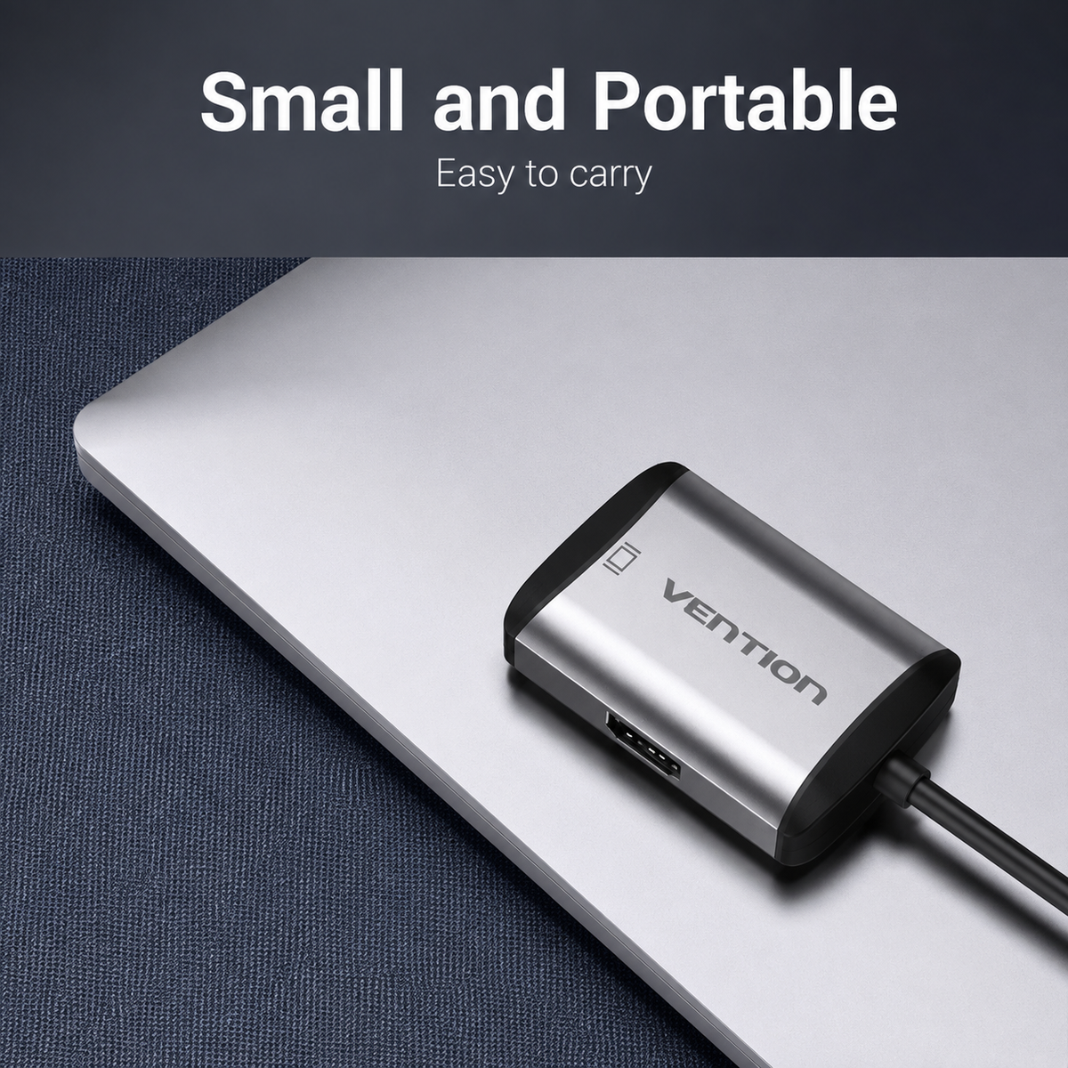 A small silver and black Vention USB adapter plugged into a silver laptop on a dark textured surface, with text at the top reading 'Small and Portable' and 'Easy to carry'.