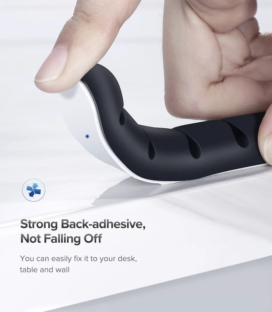 Black adhesive hook being used to attach something to a surface with text about strong adhesion.