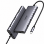 A silver aluminum 15-in-1 USB-C hub by UGREEN, featuring multiple ports on two angled views, with a black braided USB-C cable on a white background.