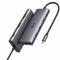A UGREEN 7-in-1 USB-C hub in dark gray aluminum, shown with two angled views of the hub body and a black braided USB-C cable on a plain white background.