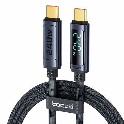 A Toocki 240W USB-C cable with two gold-plated USB-C connectors, one showing a digital LED power display and the other with a printed '240W' label. The cable is coiled with a black branded loop in the foreground against a solid white background.