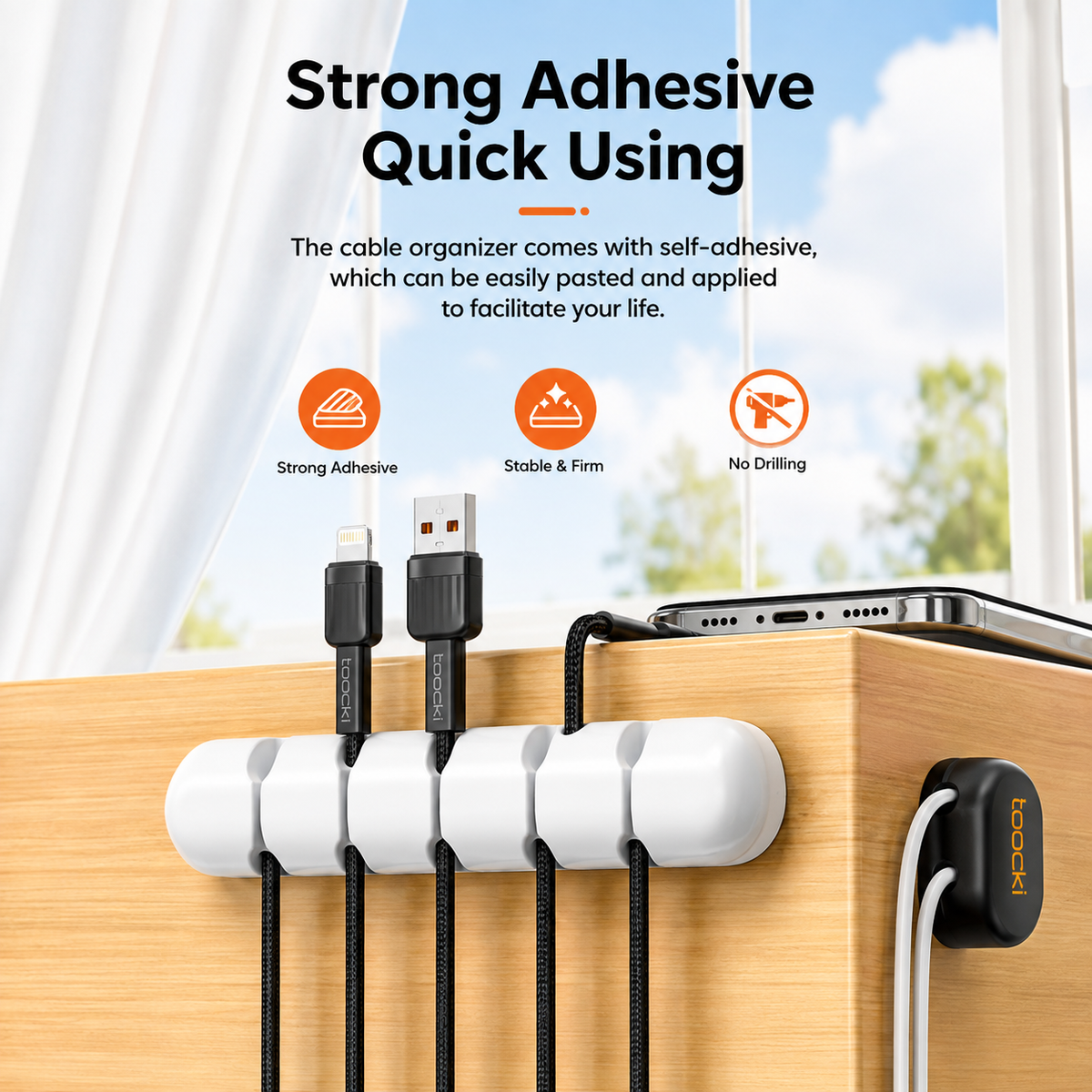 White adhesive cable organizer clips mounted on a wooden desk, holding black cables with a smartphone resting on top. Text at the top reads 'Strong Adhesive Quick Using' with feature icons for strong adhesive, stable and firm, and no drilling.