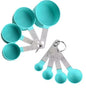 Set of turquoise measuring cups and spoons on a white background