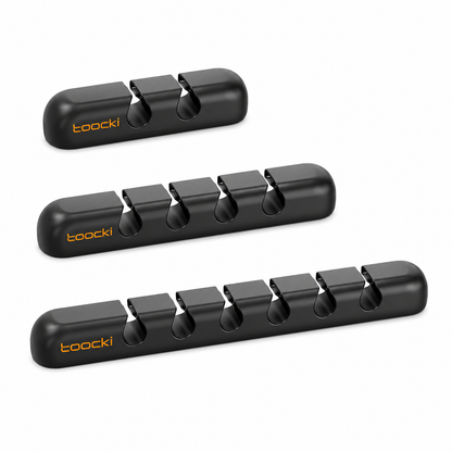 Three black Toocki sharpening stones arranged diagonally on a clean white background, with the brand name 'toocki' printed in orange on the side of each stone.