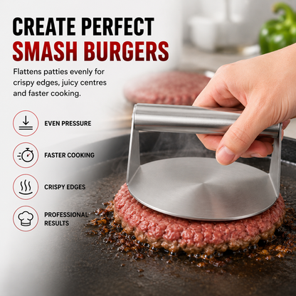 A stainless steel burger press being used by a hand to flatten a raw hamburger patty on a grill, with marketing text on the left reading 'CREATE PERFECT SMASH BURGERS' and feature icons for even pressure, faster cooking, crispy edges, and professional results.